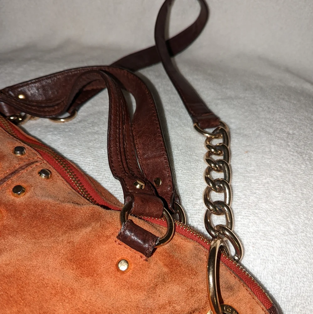 Michael Kors orange suede studded slouchy shoulder bag.
